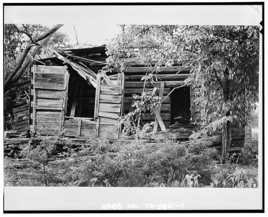 A weathered Texas log cabin showing hand-notched corner joinery